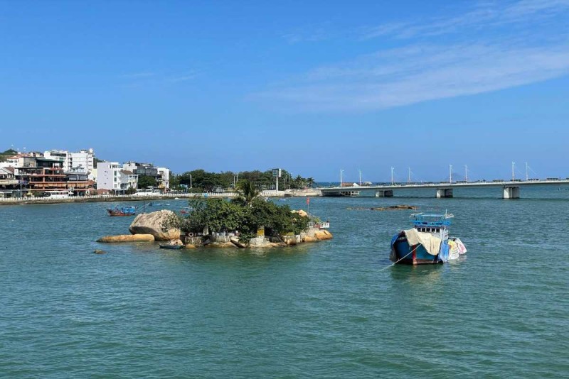 Cai River Scenic Views of Small Island and Boats Small island and fishing boats on Cai River near Nha Trang with clear skies and calm waters