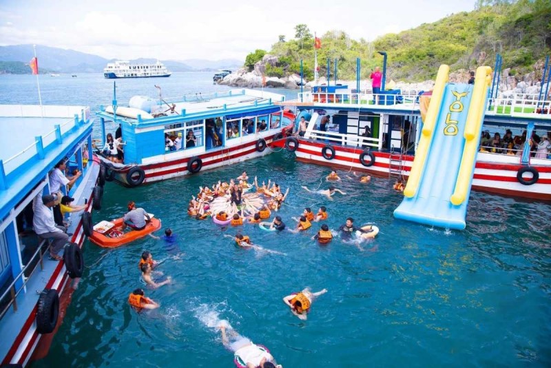 Visitors enjoy swimming and water slides at Con Se Tre Island's floating water park in Nha Trang Bay