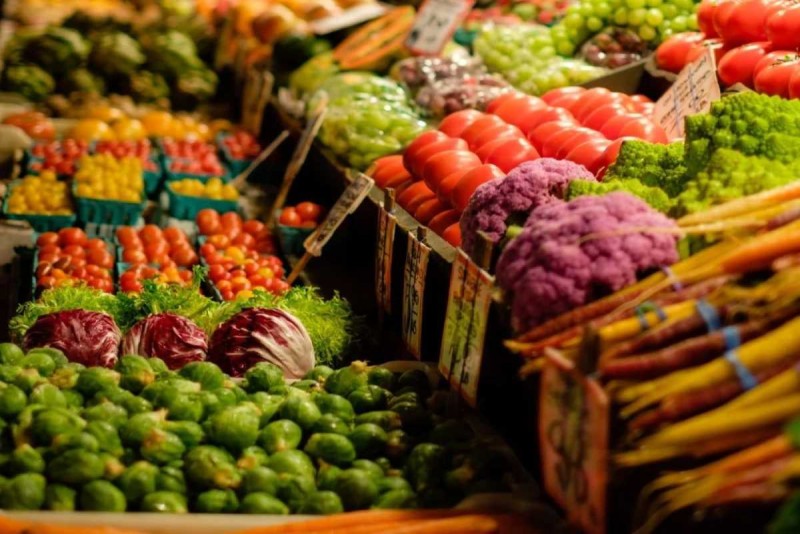 Fresh vibrant vegetables and fruits displayed at Dam Market Nha Trang with rich colors