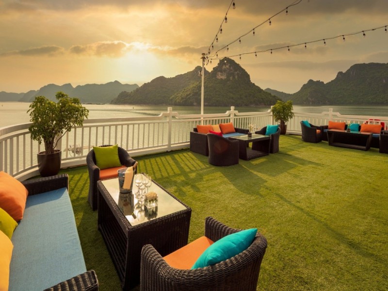 Evening Celebration on Halong Cruise Guests relaxing on deck with scenic night views