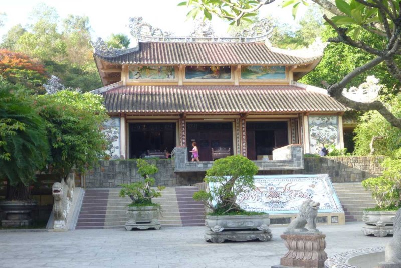 Pagoda entrance with stairs and flags Entrance of Long Son Pagoda showing traditional stairs and colorful flags in Nha Trang