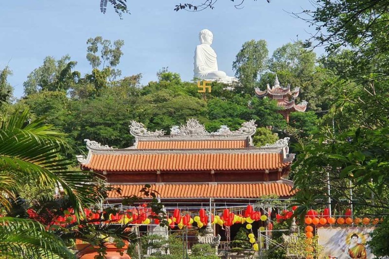 Entrance view of Long Son Pagoda The main entrance and temple buildings of Long Son Pagoda with red tiled roofs and Buddhist flags