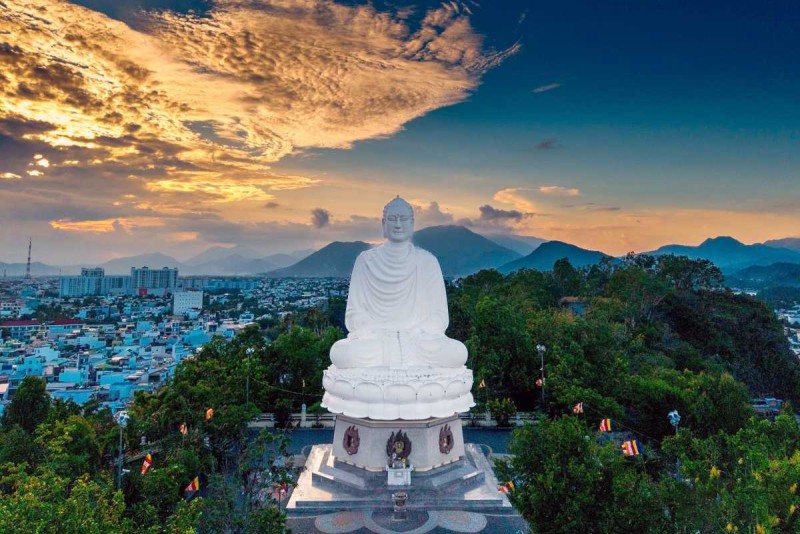 The giant white Buddha statue at Long Son Pagoda overlooking Nha Trang city and surrounding mountains
