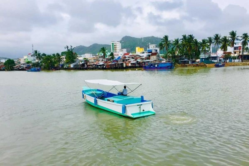 Modern Boat for Cai River Scenic Cruise in Nha Trang Modern motorboat cruising Cai River with Nha Trang city and hills in background