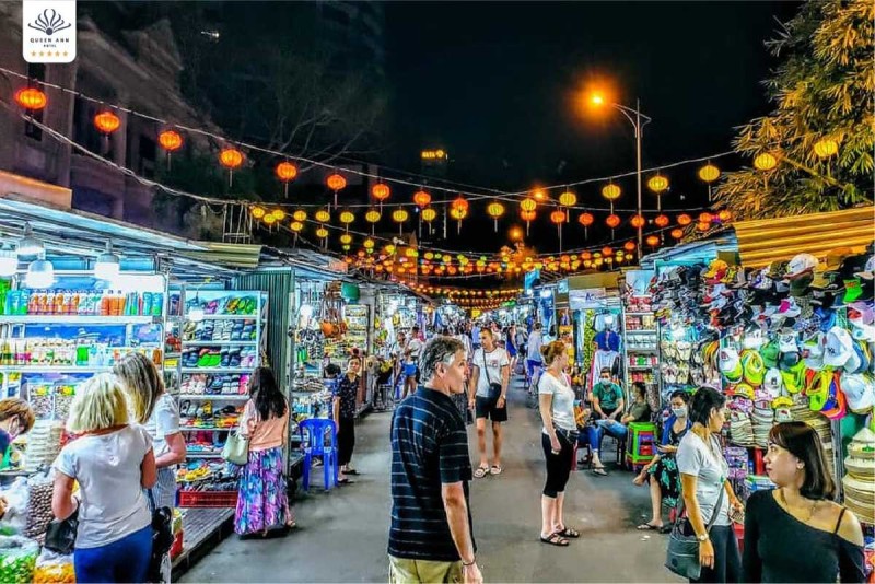 Bustling Nha Trang Night Market at night with colorful lanterns and diverse street stalls offering local goods