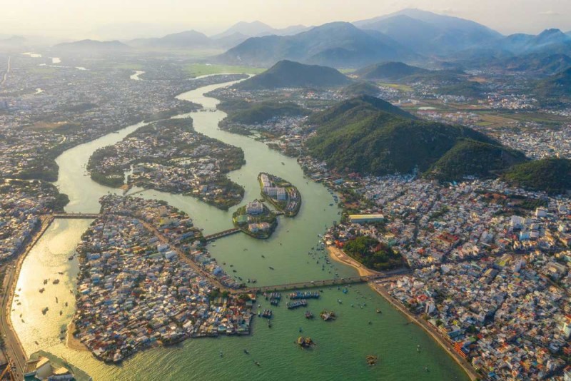 Panoramic View of Cai River and Nha Trang Wide panoramic scene showing Cai River winding through Nha Trang with boats and swimming spots