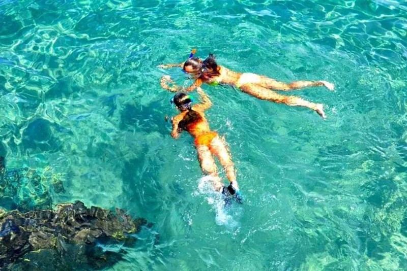 Snorkeling at Hon Mot Island Nha Trang Two snorkelers enjoying crystal-clear water and diverse marine life while snorkeling at Hon Mot Island