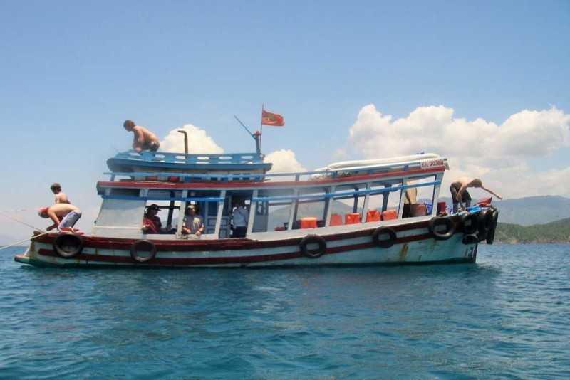 Snorkeling and Marine Life at Mun Island Snorkelers swimming over vibrant coral reefs near boats off Mun Island coast