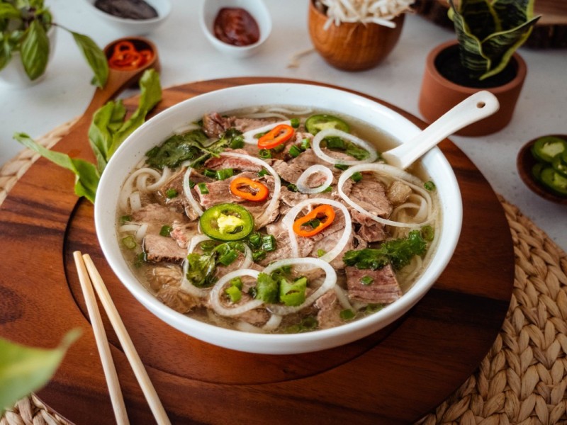 A Perfect Bowl of Traditional Pho Bo A traditional Vietnamese beef noodle soup with fresh herbs and noodles