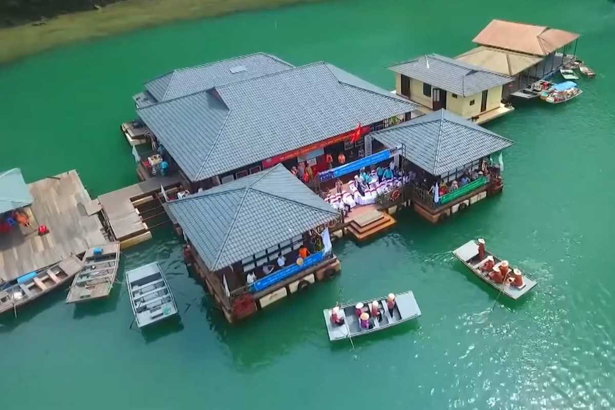 Overhead shot showing colorful floating houses and boats in Cong Dam Fishing Village on Bai Tu Long Bay