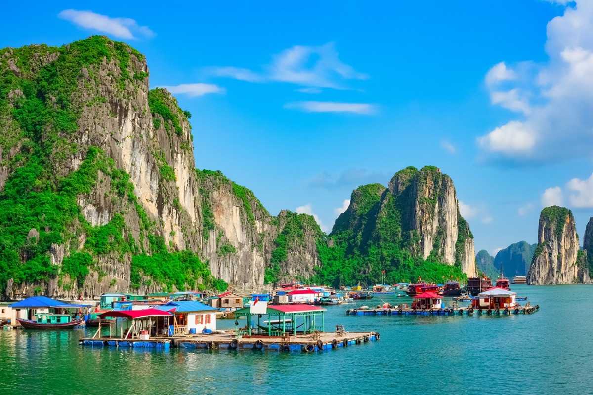 Aerial view of Tung Sau Pearl Farm Halong Bay showing oyster beds, floating houses, and limestone karsts in the distance