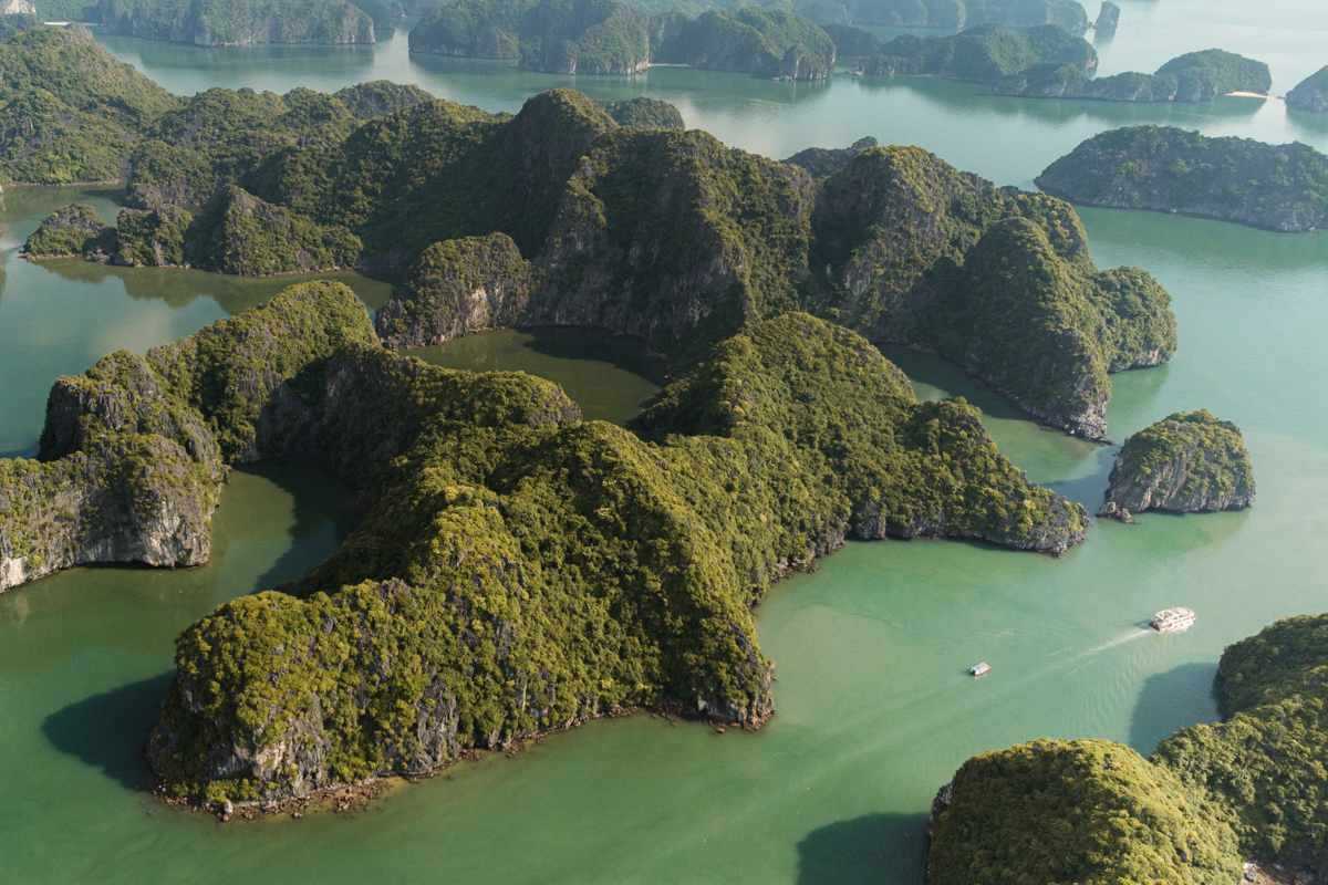 Aerial view capturing limestone karsts and clear waters of Ba Ham Lake Halong Bay