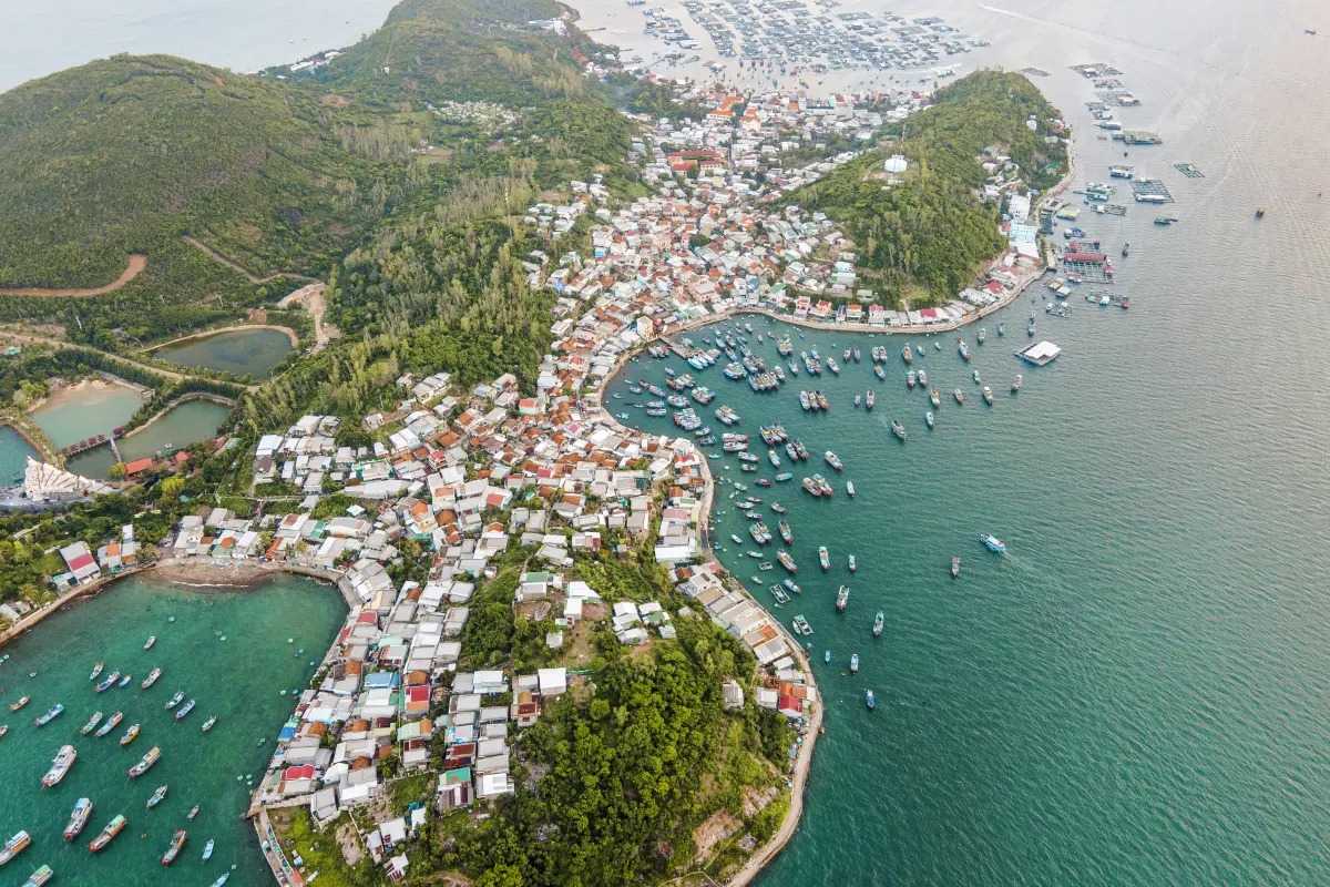 Aerial view of Bai San Beach and fishing village in Nha Trang, showing coastal landscape and boats