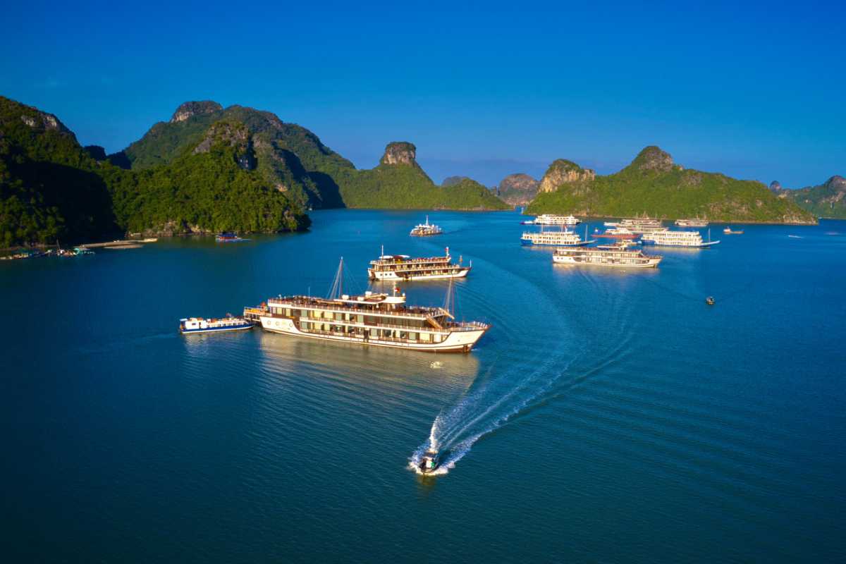 Aerial photo of limestone islands and turquoise waters in Bai Tu Long Bay close to Quan Lan Island