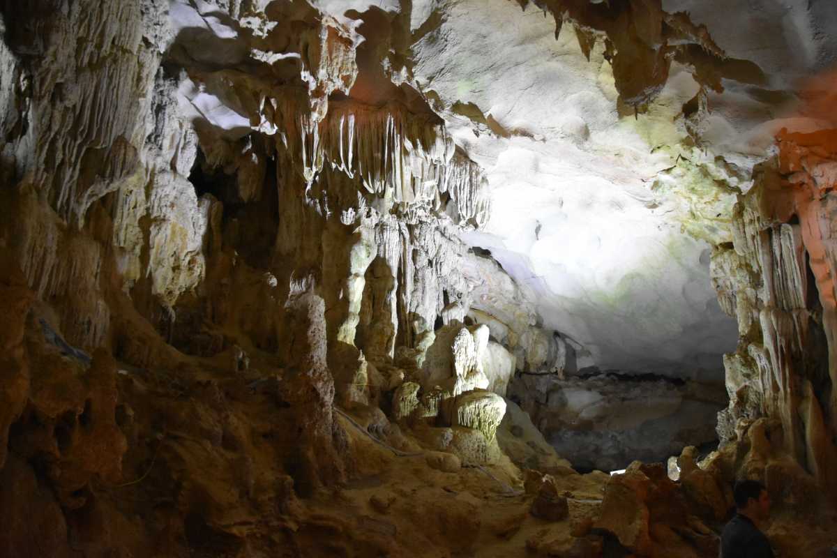 Inside Bo Nau Cave, with illuminated stalactites and rock formations creating a natural wonder.