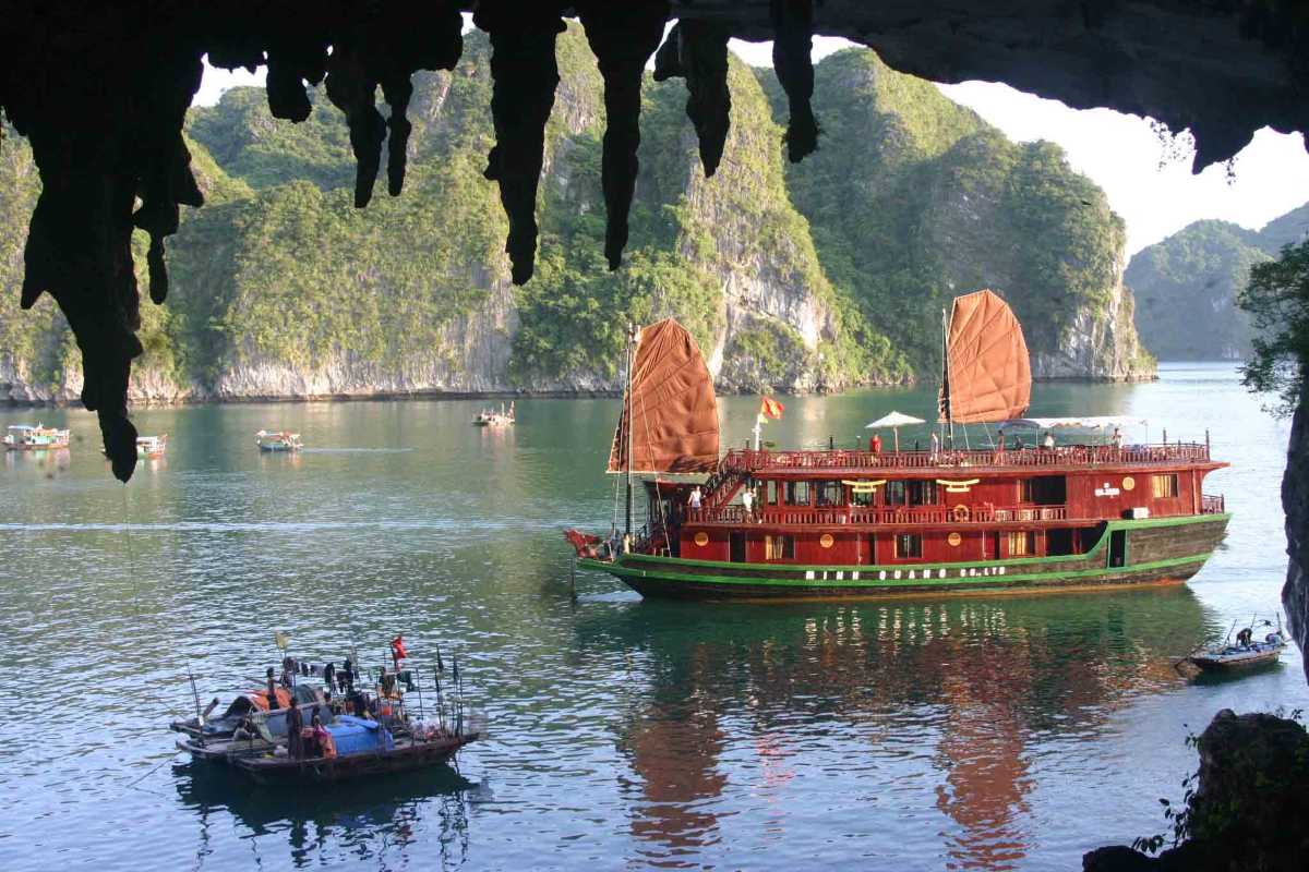 Bo Nau Cave Halong Bay framed by natural cave formations, with crystal-clear waters and towering karsts.