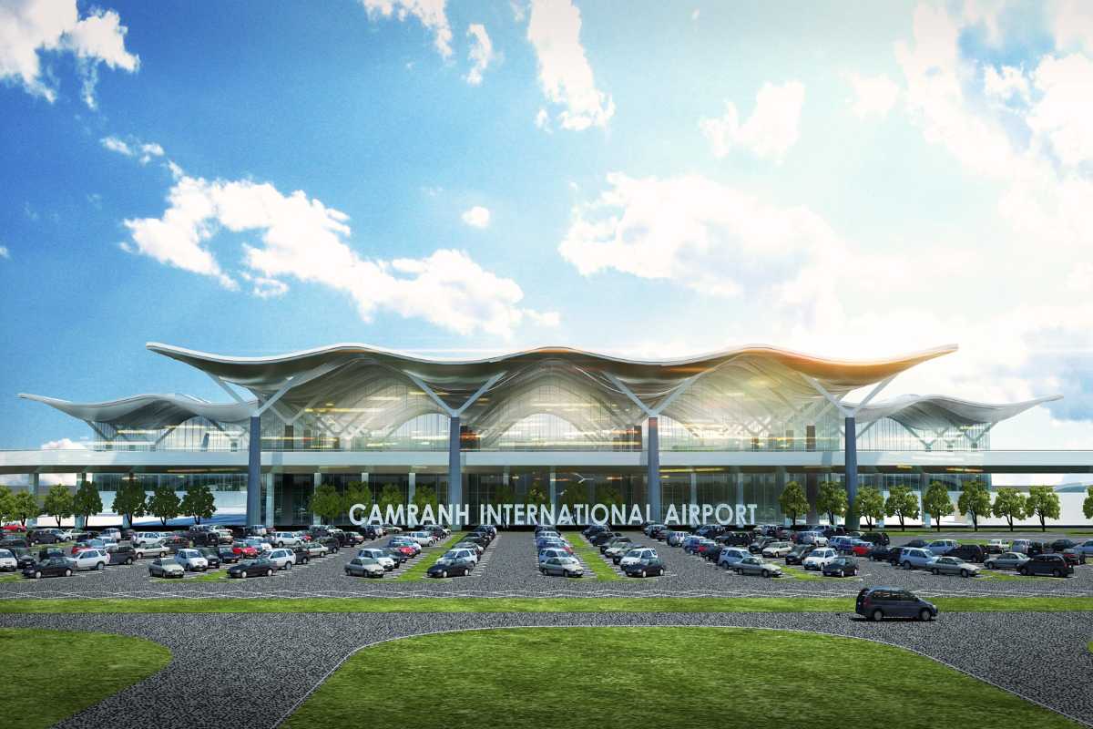 Modern exterior view of Cam Ranh International Airport terminal with parking area and blue sky