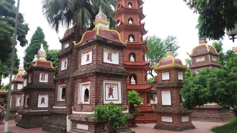 Close-Up of Shrines at Tran Quoc Pagoda A close-up view of shrines at Tran Quoc Pagoda, with intricate brickwork and sacred Buddhist inscriptions.