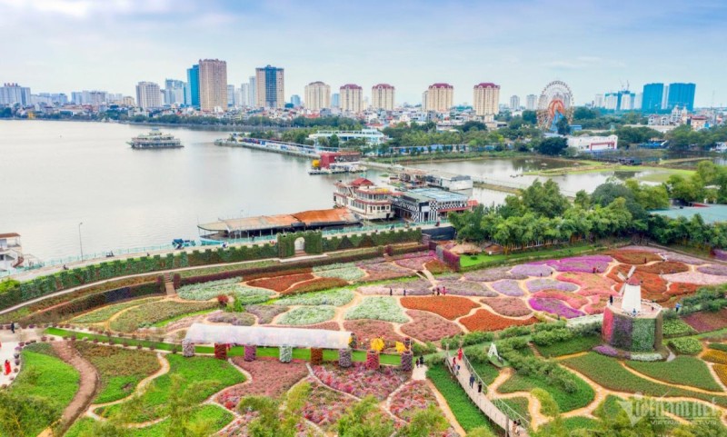 Colorful Flower Valley at Hanoi West Lake Aerial view of Flower Valley near West Lake Hanoi with vibrant flowerbeds and a serene lake in the background.