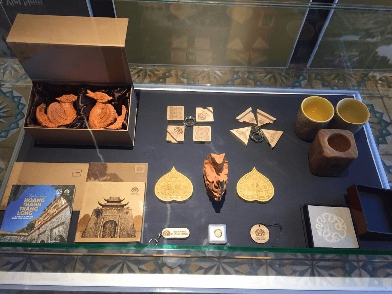 Cultural Souvenirs from the Imperial Citadel of Thang Long A collection of cultural souvenirs and artifacts from the Imperial Citadel of Thang Long, including figurines, mugs, and decorative pieces.