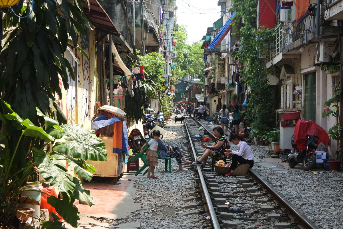 Daily life on Hanoi Train Street with locals and tourists