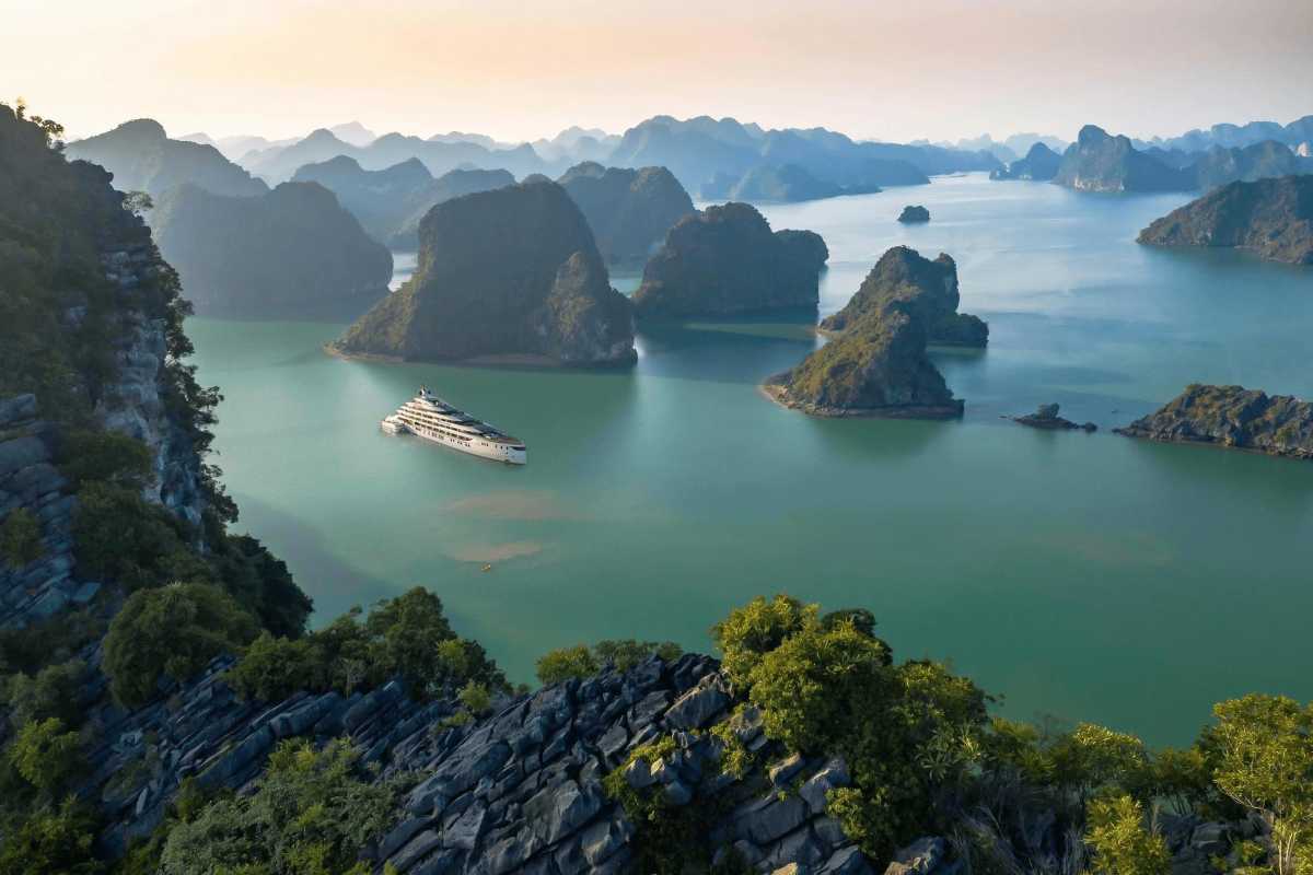 Aerial view of limestone islets and boats in Dinh Huong Islet Halong Bay