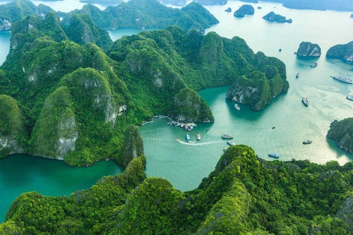 Limestone rock formation near a cruise boat at Dinh Huong Islet Halong Bay