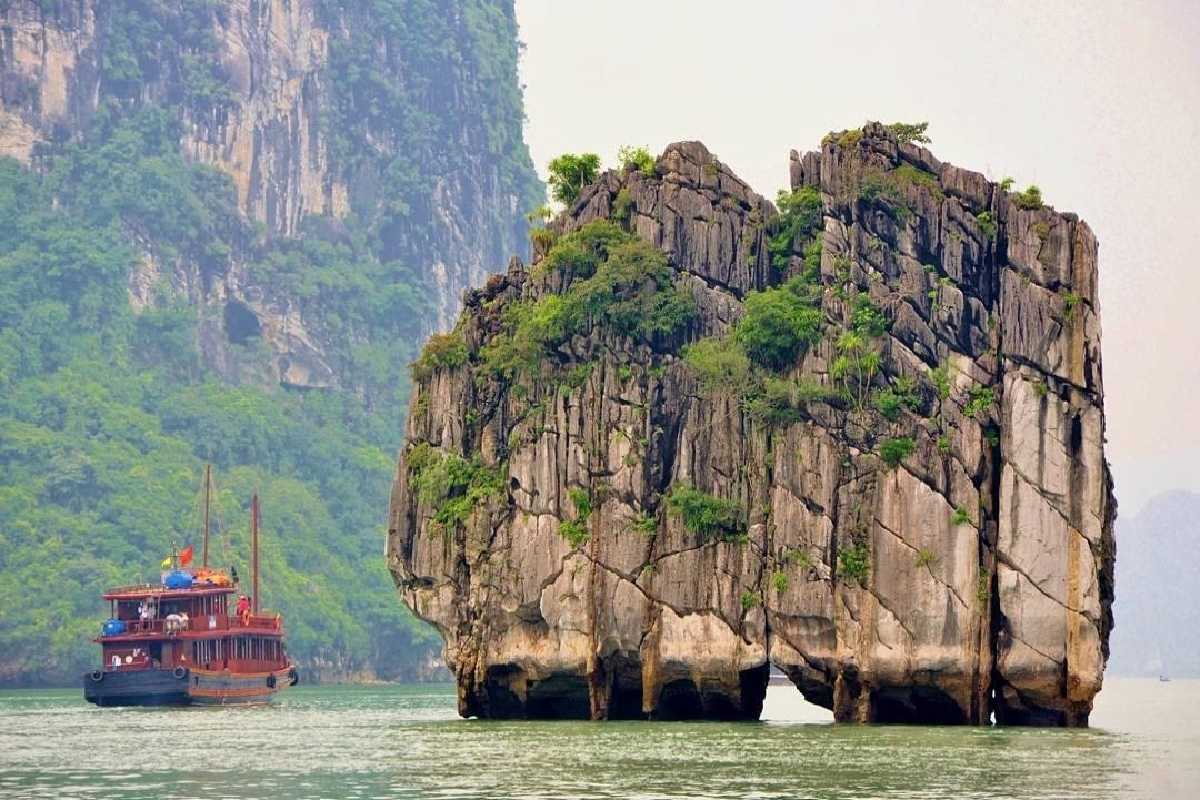 Scenic limestone bay view with boats near Dinh Huong Islet Halong Bay