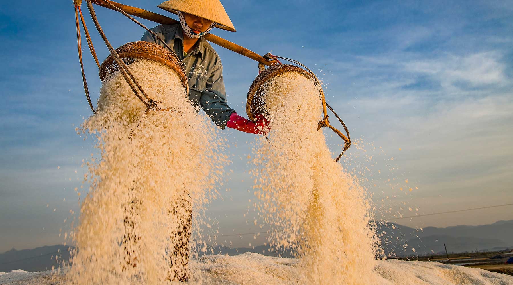 Evening Salt Harvesting Scene at Hon Khoi Commune Evening light on salt harvesting activities in Hon Khoi Commune salt fields