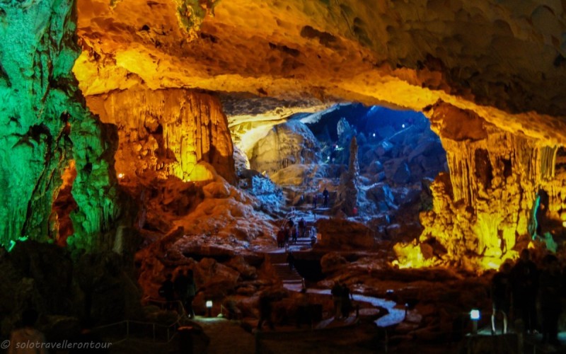 Expansive Chamber of Sung Sot Cave, Halong Bay Wide shot of the spacious chamber inside Sung Sot Cave, Halong Bay, with vivid lighting illuminating the towering rock formations.