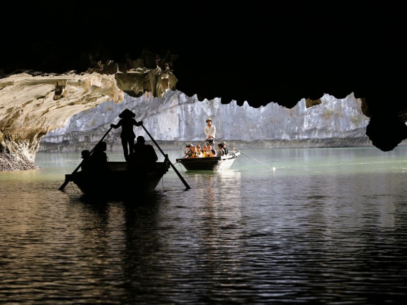 Exploring Dark and Bright Caves by Bamboo Boat Bamboo boat exploring the mystical Dark and Bright Caves in Halong Bay