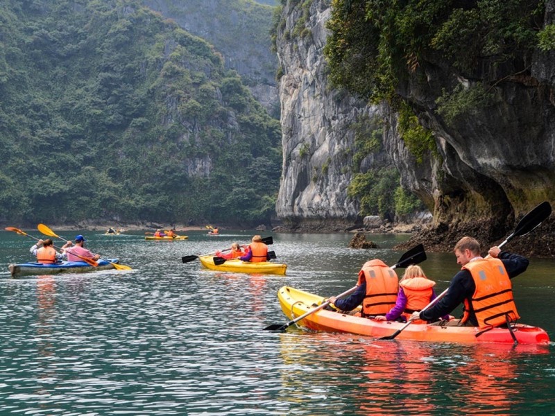 Family Kayaking Adventure in Lan Ha Bay Families kayaking together in the serene waters of Lan Ha Bay