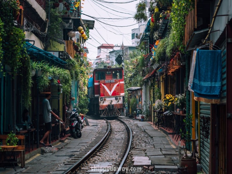 Famous Hanoi Train Street with colorful cafés and railway