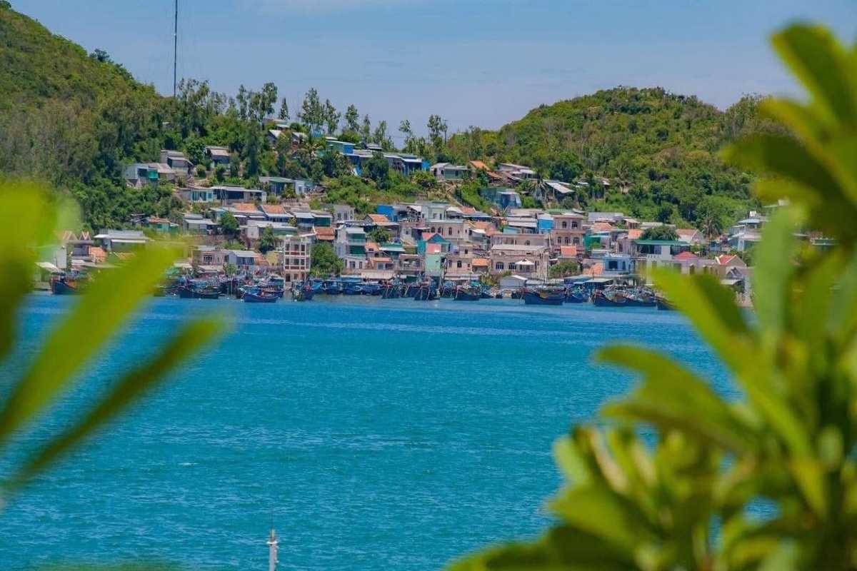 Fishing village near Cau Da Port Nha Trang Traditional fishing village across from Cau Da Port Nha Trang with colorful houses and fishing boats.