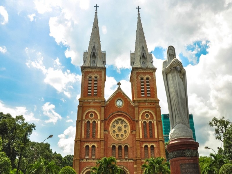 Front Facade of Notre-Dame Cathedral Saigon with Virgin Mary Statue Front facade of Notre-Dame Cathedral Saigon with Virgin Mary statue in front