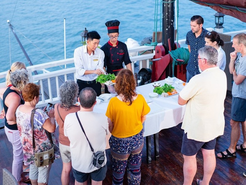 Guests Enjoying a Cooking Class on Halong Bay Guests enjoying a cooking class on Halong Bay cruise.