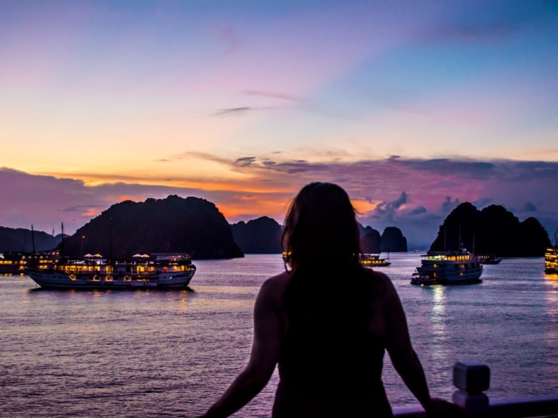 Halong Bay Luxury Cruise at Sunset A luxury cruise sailing through Halong Bay at dusk.