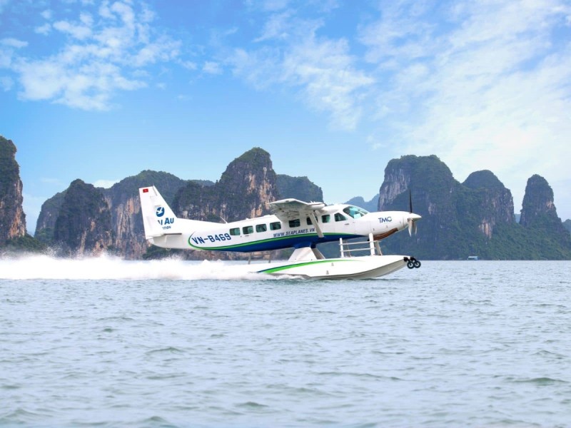 halong-bay-seaplane-titov-island.jpg A seaplane taking off from the waters of Halong Bay, with towering limestone cliffs in the background near Titov Island.
