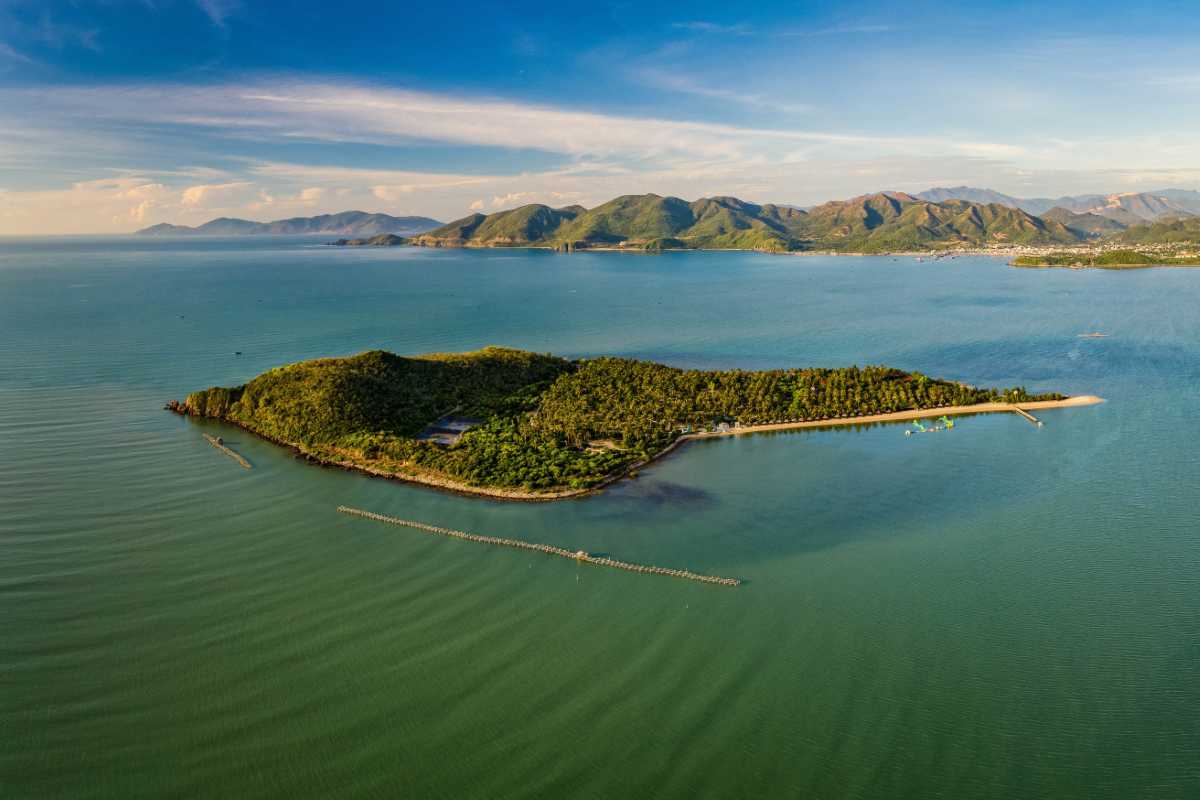 Natural aerial view of Hon Lao Island showing lush greenery and clear surrounding waters of Nha Trang