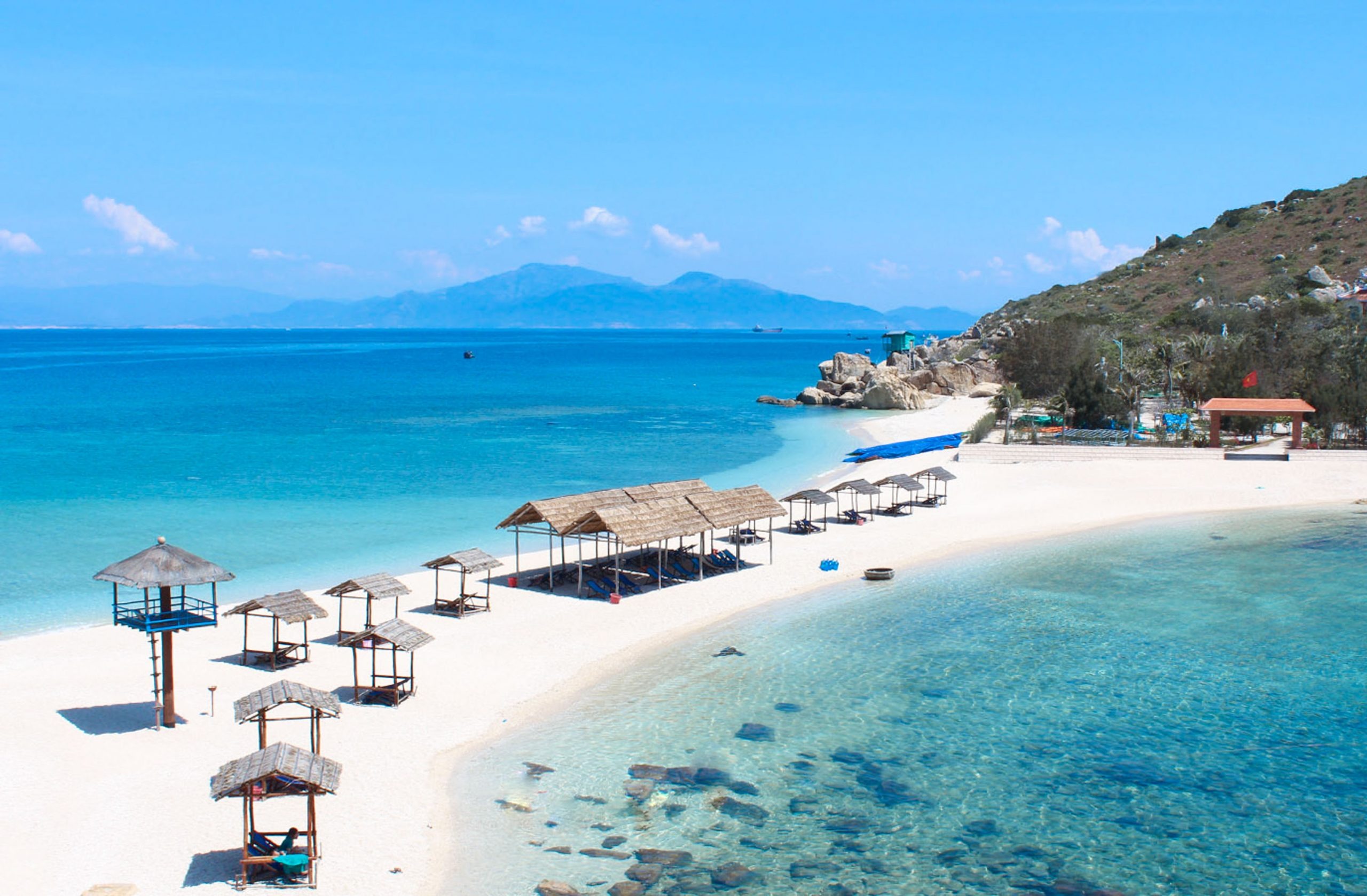 Pristine white sand beach at Hon Noi Islands with clear turquoise waters in Nha Trang