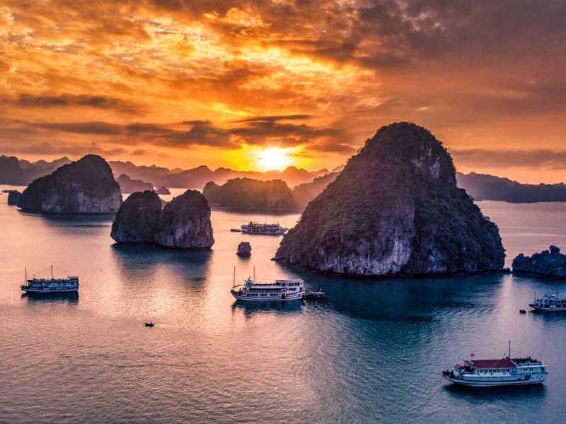 Iconic Sunset View on Halong Bay Iconic sunset scenery of Halong Bay with cruises.