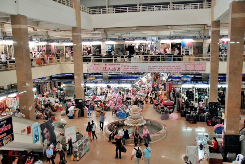 Inside Dong Xuan Market with Shops and Shoppers Inside Dong Xuan Market, where shoppers explore various stalls filled with clothes, souvenirs, and other items