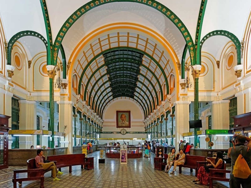 Inside the Saigon Central Post Office Inside the Saigon Central Post Office with tourists and a large portrait of Ho Chi Minh
