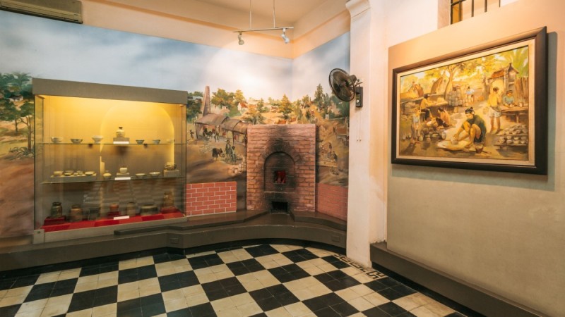 Interior Exhibit at Hoa Lo Prison An exhibit inside Hoa Lo Prison showing historical artifacts and a model of life during the colonial period in Vietnam.