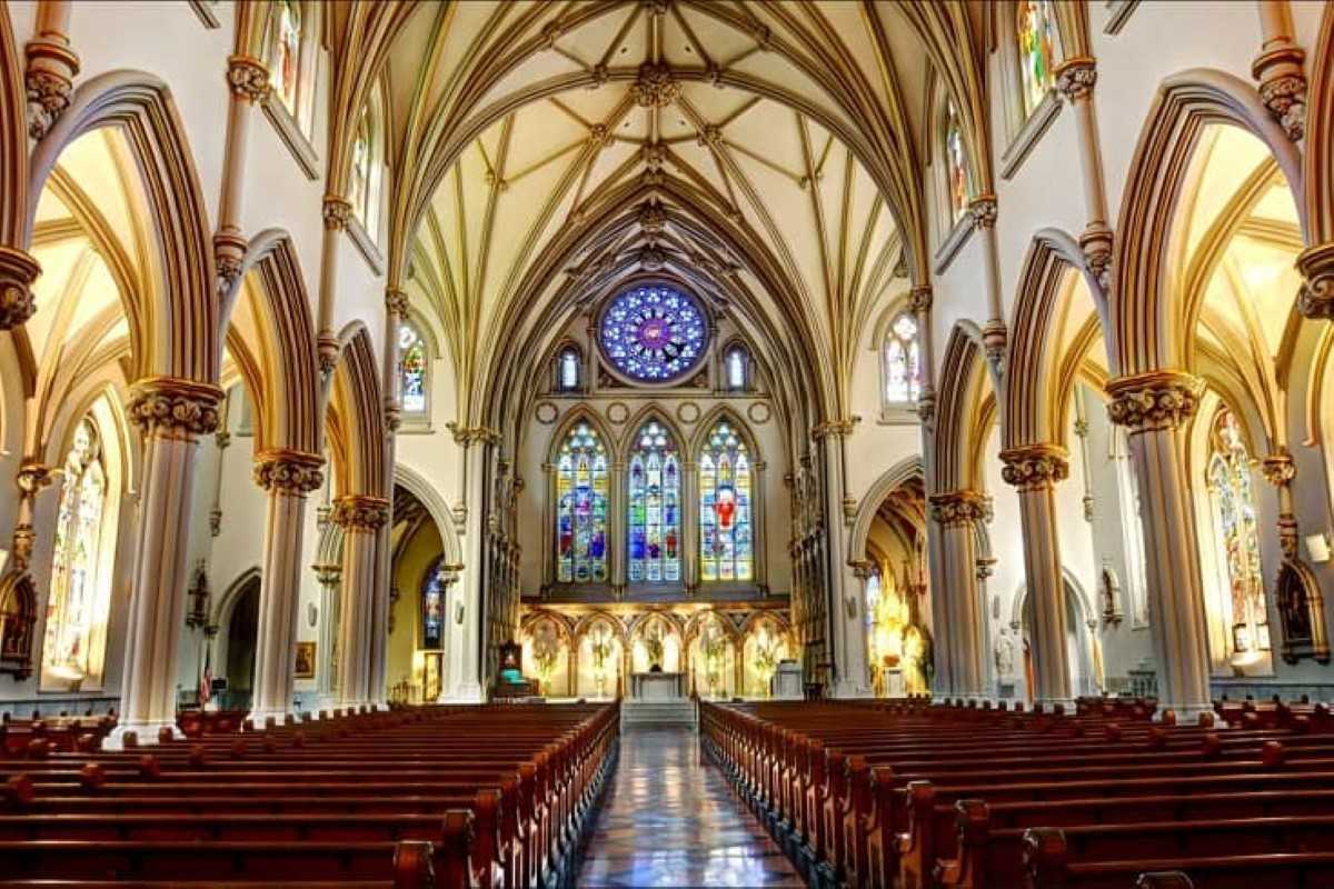 Interior of St. Joseph’s Cathedral Hanoi with Stained Glass Stunning view of St. Joseph’s Cathedral Hanoi interior with stained glass, arched ceilings, and polished pews