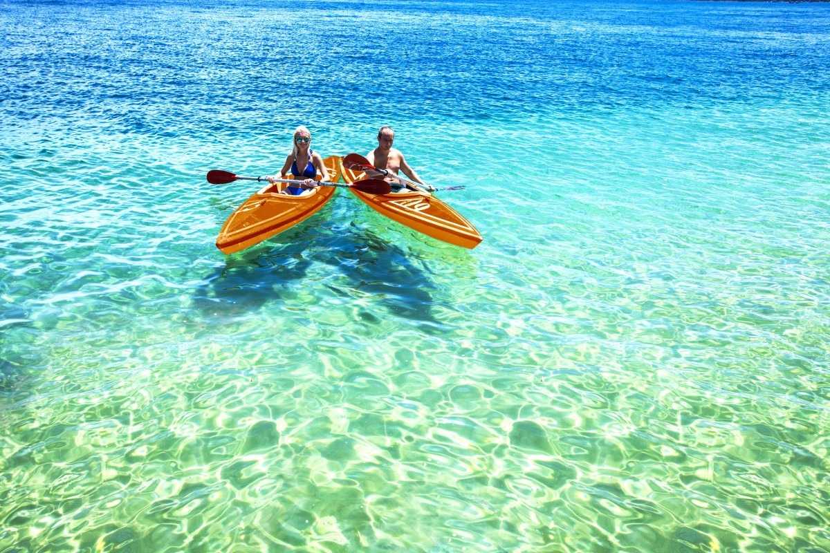 Two people kayaking on turquoise water off Hon Mot Island's eastern shore