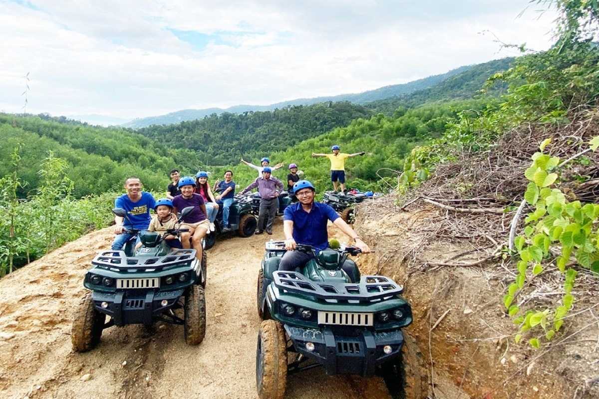 Group riding all-terrain vehicles on dirt trails through Kong Forest at Hon Ba Nature Reserve