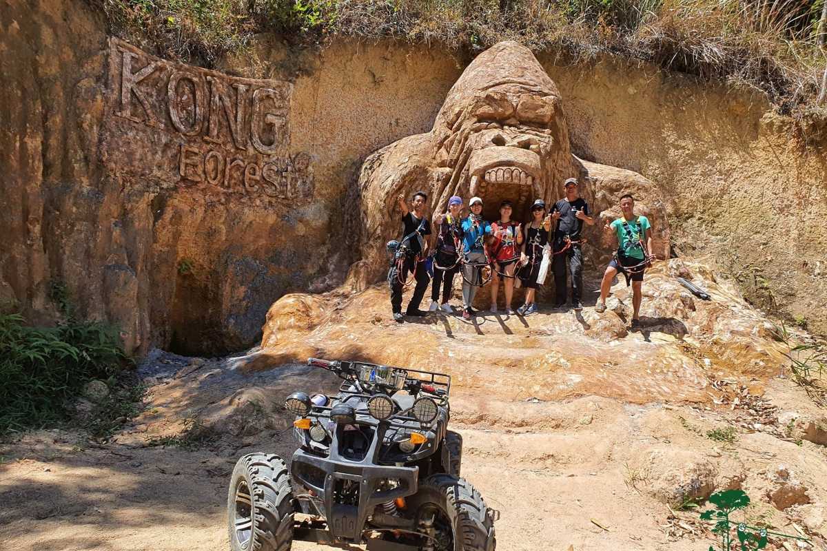 Entrance to Kong Forest at Hon Ba Nature Reserve with group of trekkers and quad bike