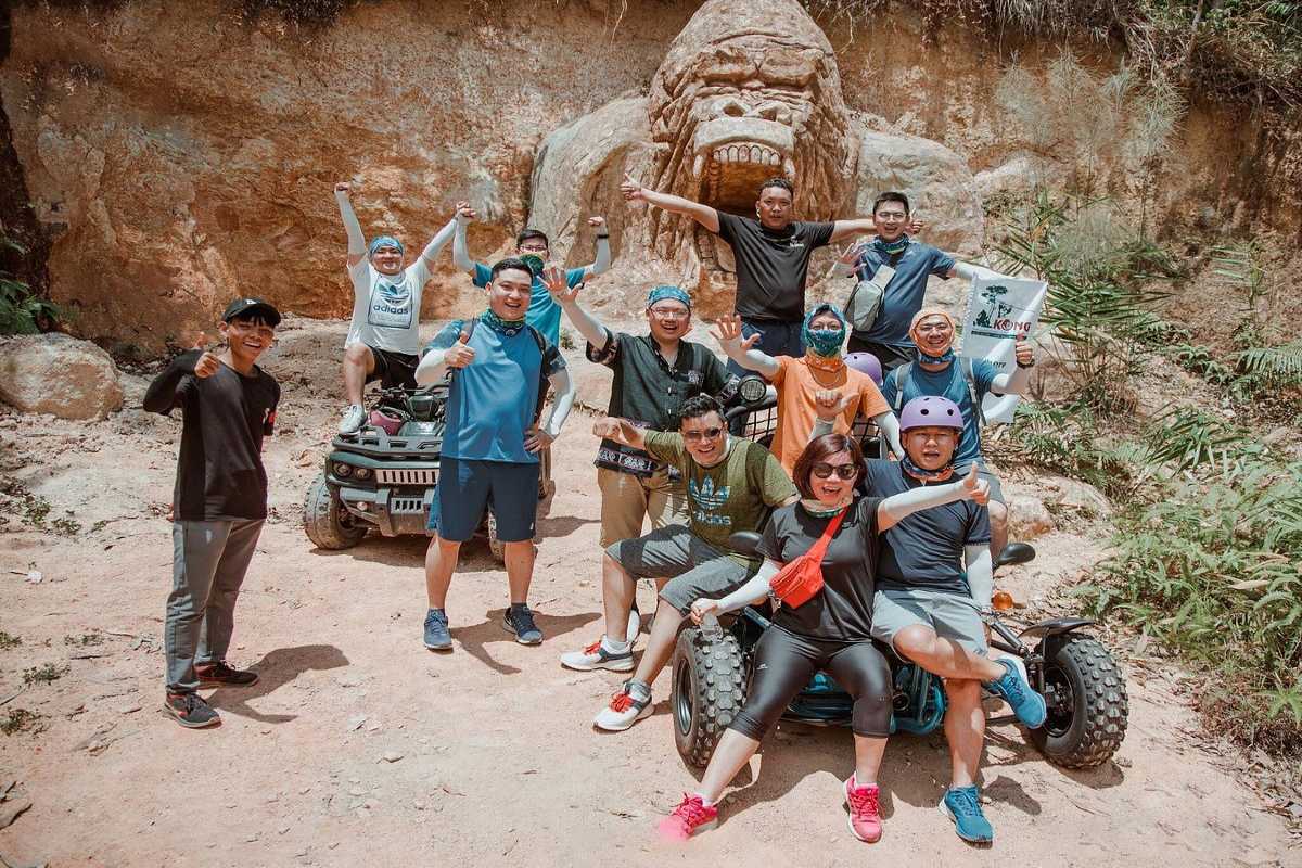 Group of tourists posing with ATVs at Kong Forest entrance in Hon Ba Nature Reserve