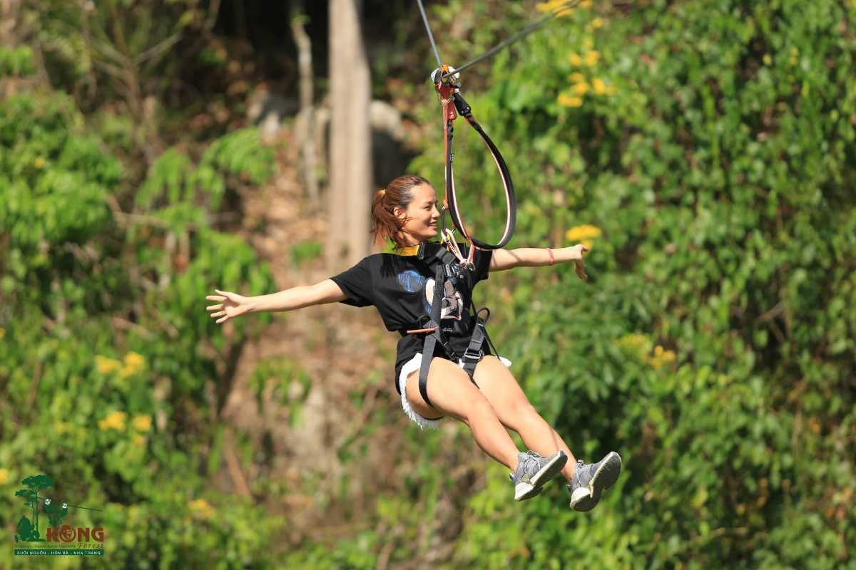 Tourist enjoying zipline ride through forest canopy in Kong Forest at Hon Ba Nature Reserve